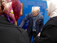 Tour Guide, Mr Noel Large, explains a mural during a tour of the Shankhill Road area in Belfast.