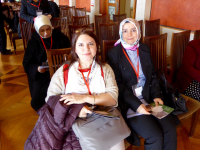 Ms Fadime Özkan and Ms Ayşe Koytak wait for the Easter Rising Commemoration to begin at the Stormont House in Belfast.